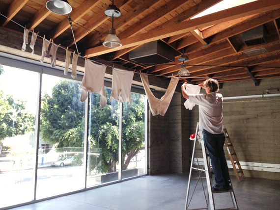 artist Greg Colson installs his constructed painting, “Lights and Delicates”